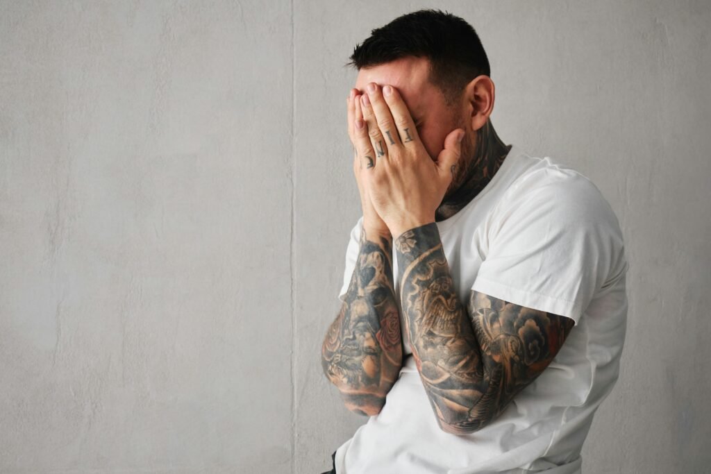 Man with head in hands sad